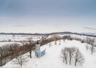 small blue chapel with snow